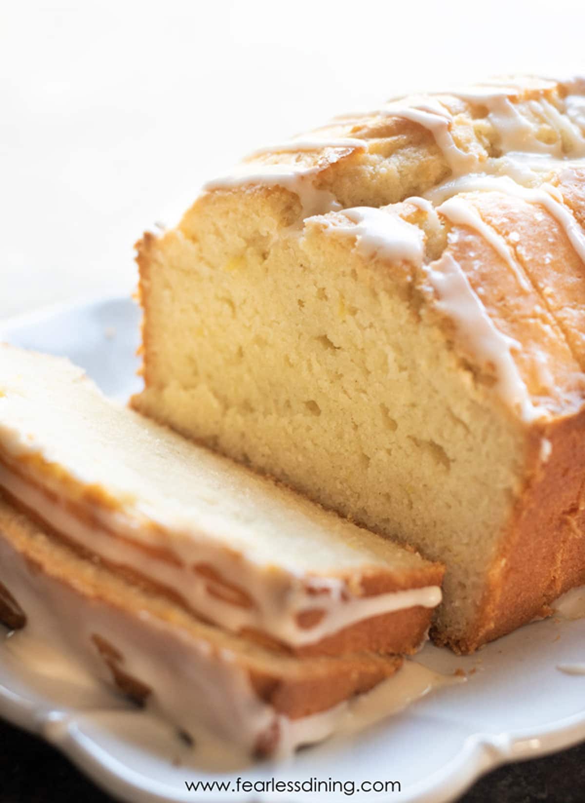 A sliced gluten free lemon pound cake on a platter.