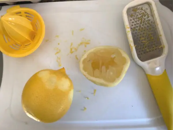 lemons next to a lemon zest tool