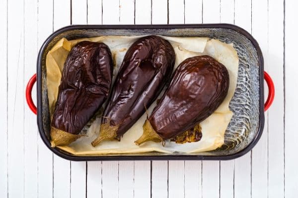 Roasted eggplants on a tray.