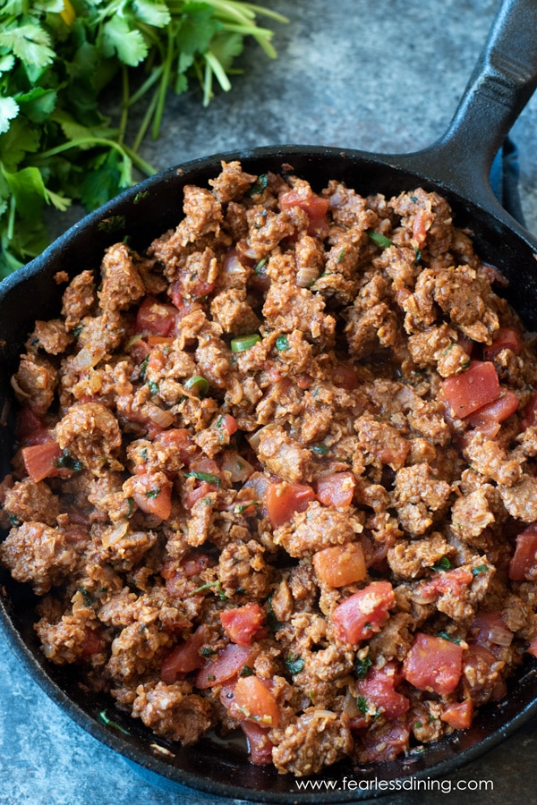 A skillet full of vegan meat filling for the casserole.