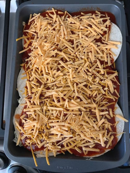 Casserole is topped with enchilada sauce and dairy-free cheddar cheese.