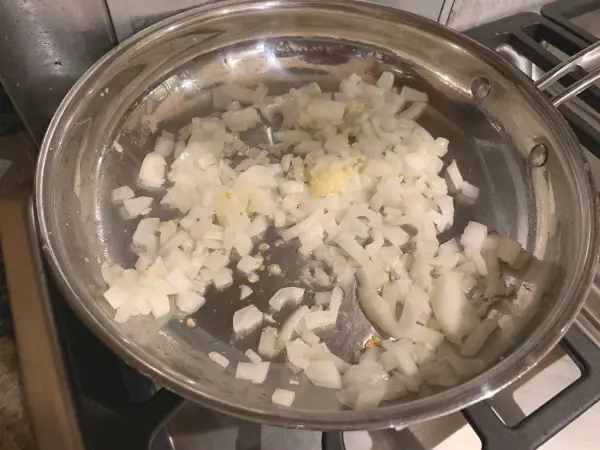 Cooking onion and garlic in a pan.