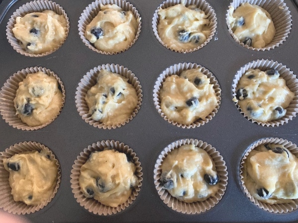 Muffin batter in a muffin tray.