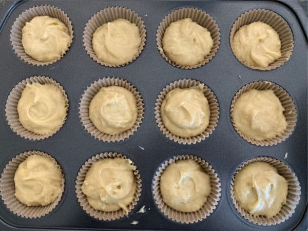 Cupcake batter in a muffin tin ready to bake.