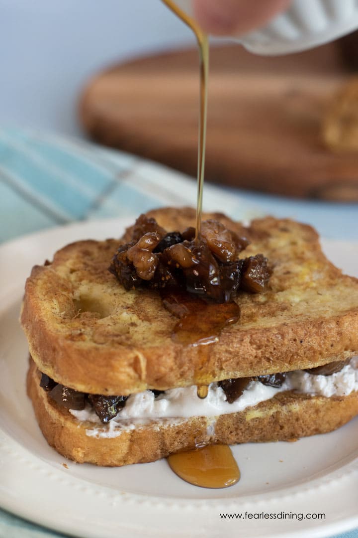 Drizzling syrup over the French toast.