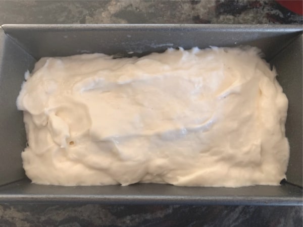 Sourdough loaf rising in a pan.