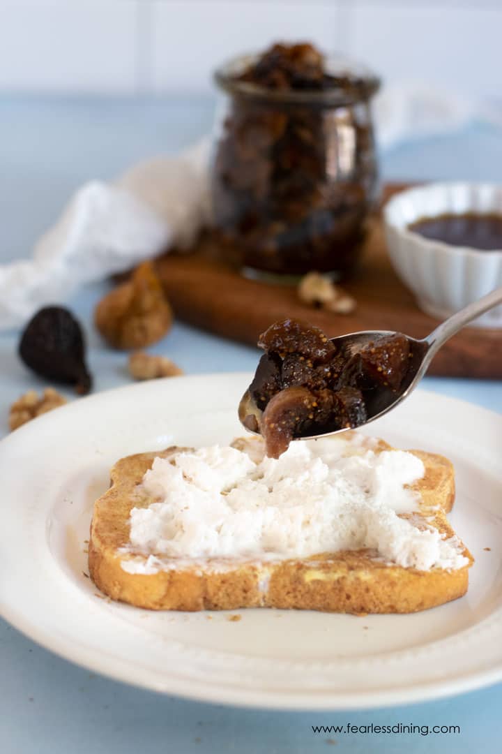 Spooning fig and walnut chutney over a slice of French toast