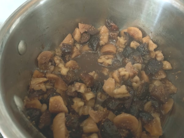 Cooking chutney on the stove in a small silver saucepan