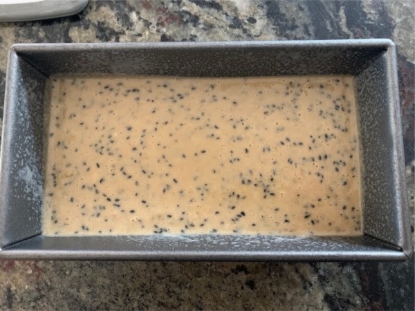 Sesame banana bread batter in a loaf tin ready to bake.