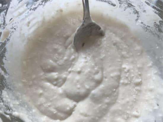 Mixing the bread dough with starter batter.