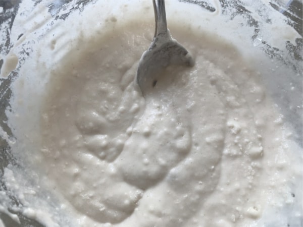 Mixing the bread dough with starter batter.