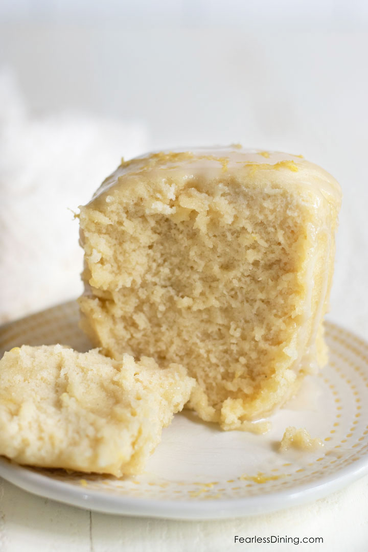 A lemon mug cake with a piece cut out.