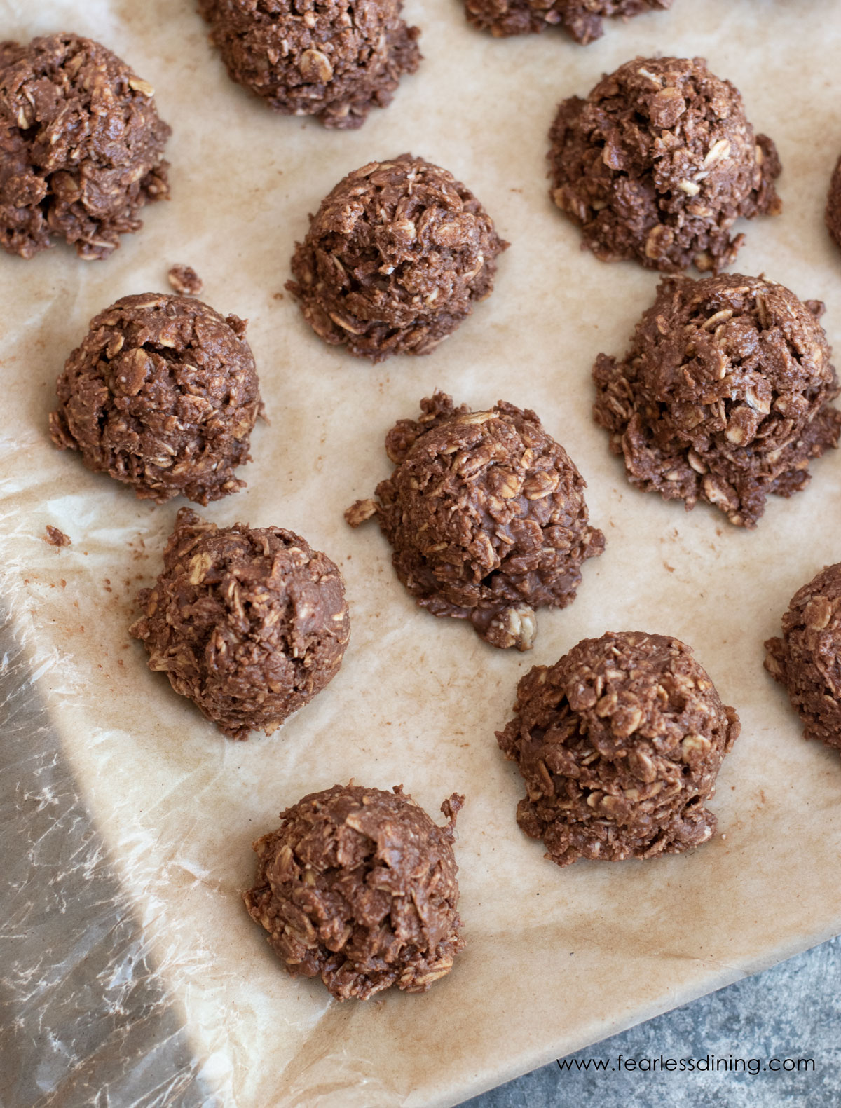 The top view of chocolate oat cookies on wax paper.