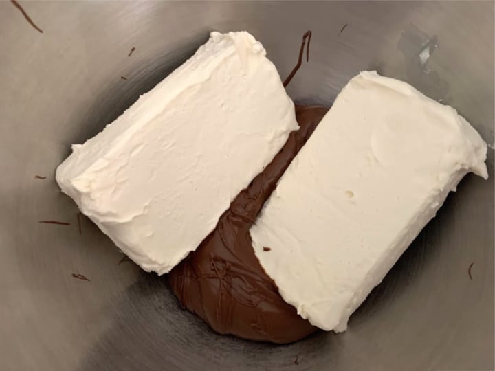 Cream cheese and Nutella in a mixing bowl.
