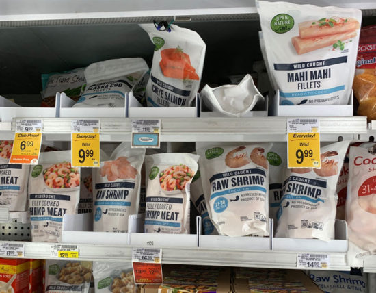 Seafood in a freezer at the grocery store.