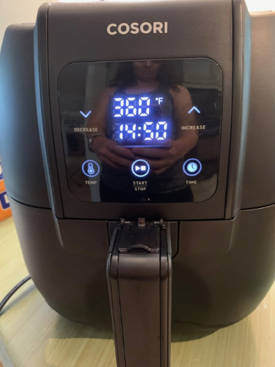 Setting the air fryer cooking time.