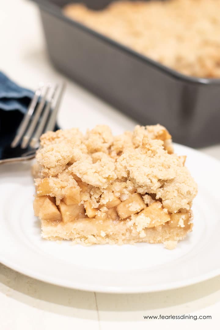 A slice of apple crumble bar on a plate.