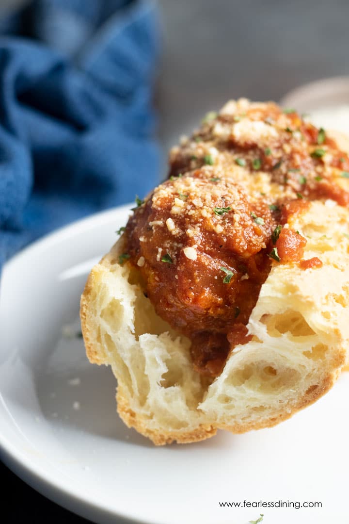 A front view of the meatball sub on a plate.