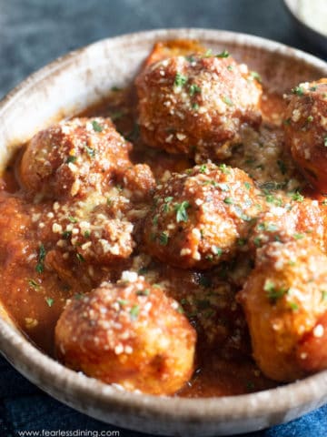 A bowl filled with turkey meatballs and sauce.