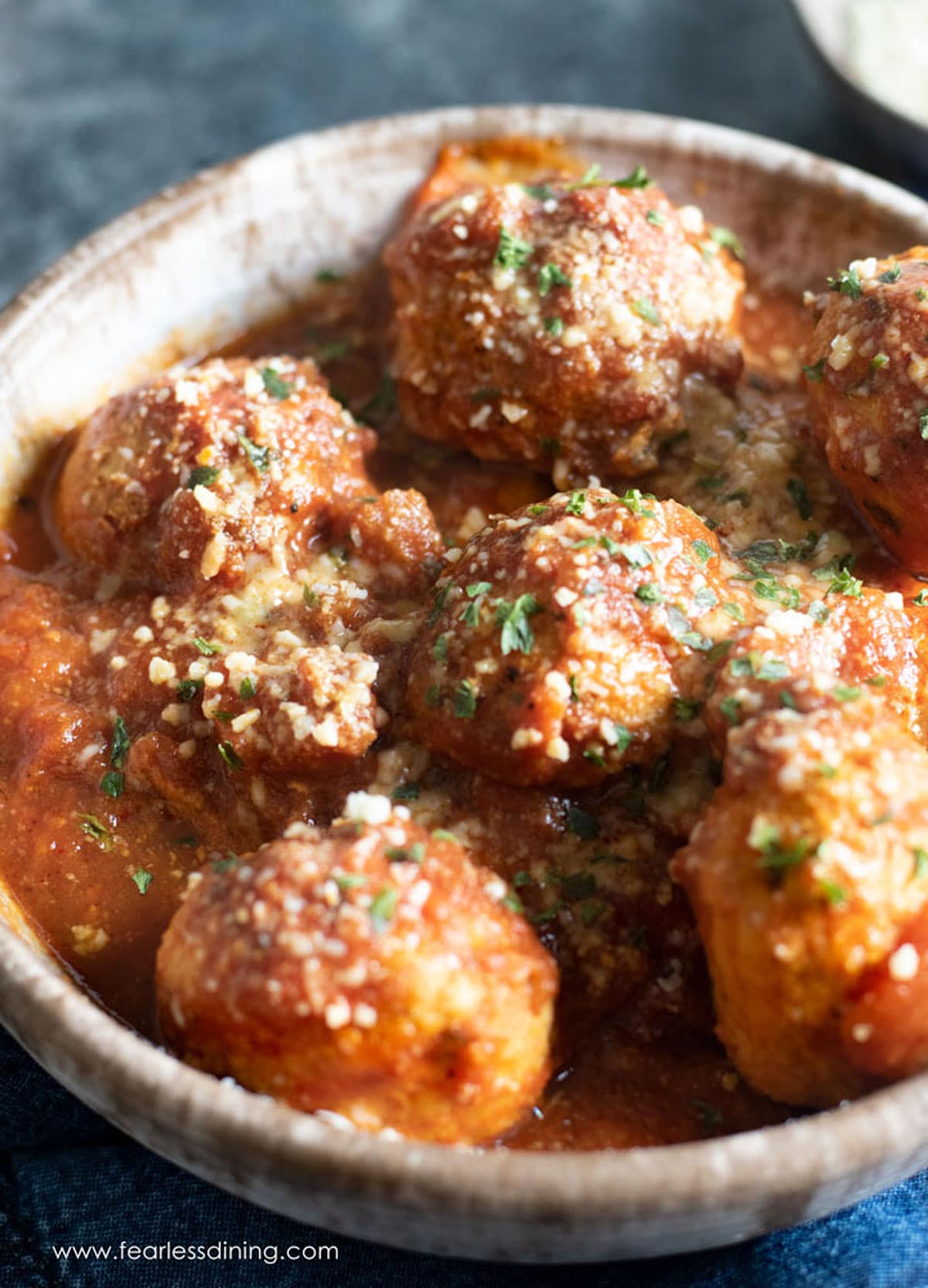 A bowl filled with turkey meatballs and sauce.