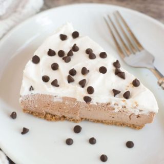 A closeup of a slice of Nutella cheesecake on a white plate.