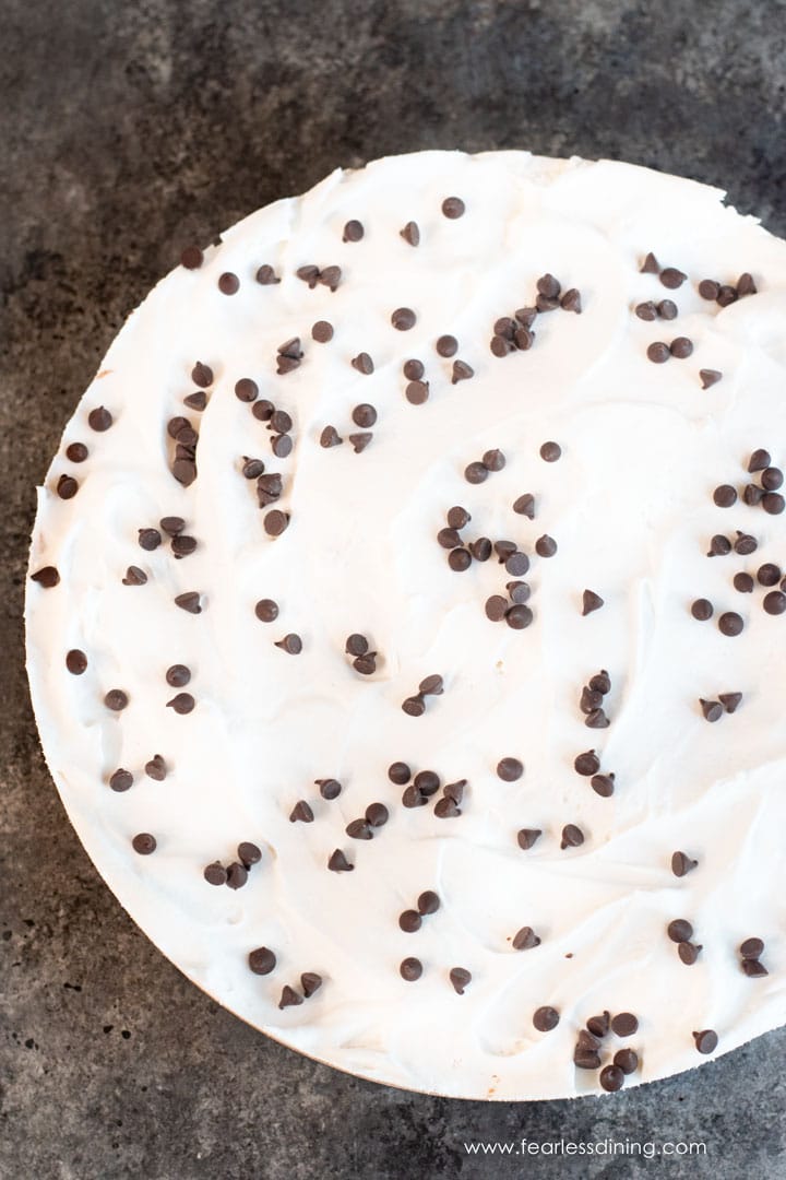 The top view of a whole whipped cream topped no-bake Nutella cheesecake.