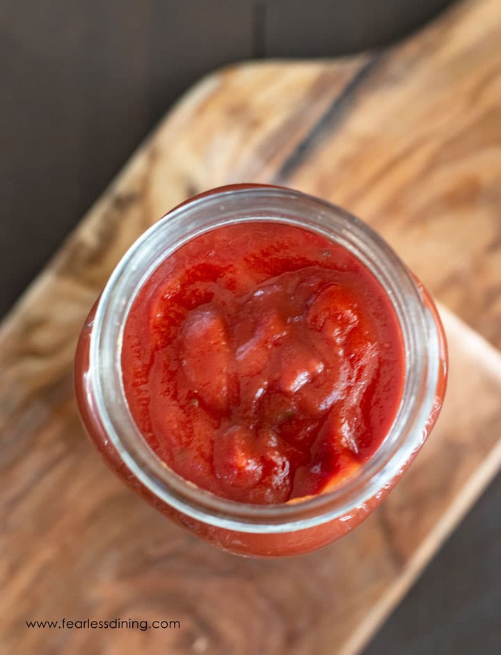 top view of a mason jar filled with pizza sauce.