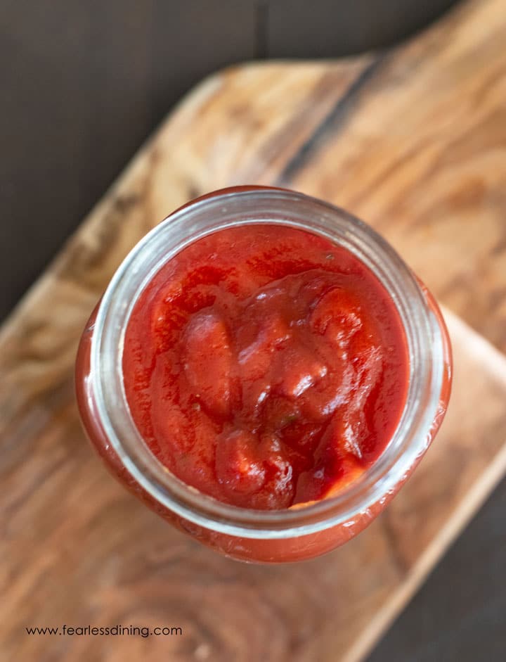 The top view of a mason jar filled with pizza sauce.