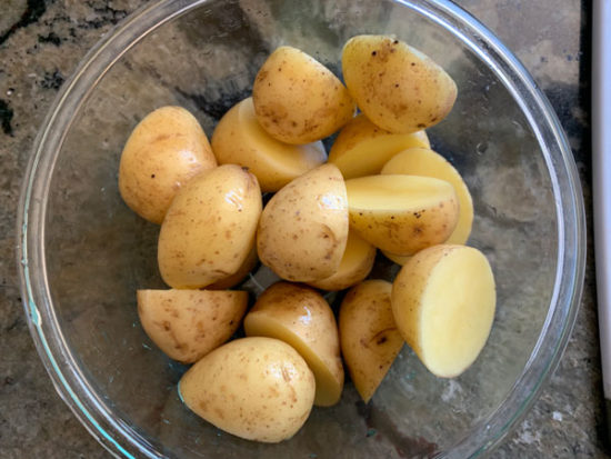 Washed and cut potatoes in a bowl.