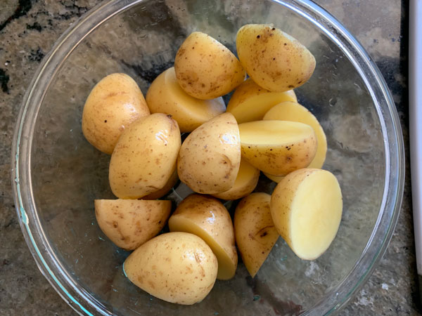 Washed and chopped potatoes in a bowl.