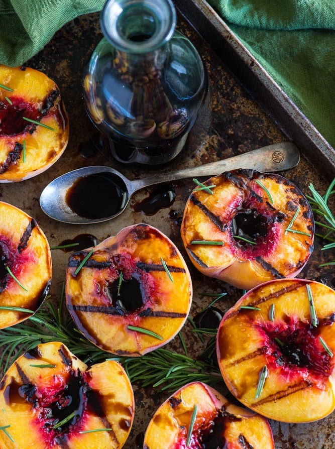 Grilled peaches on a sheet pan.