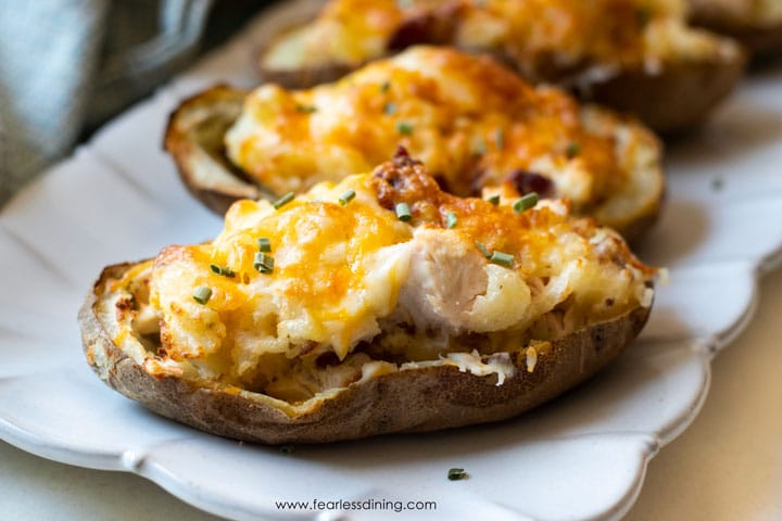 Four twice baked potatoes on a platter.