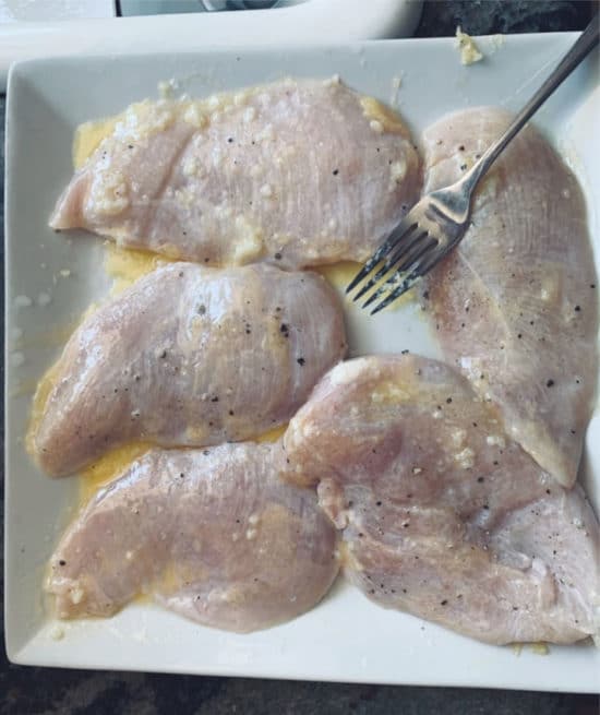 Marinating the chicken breasts.