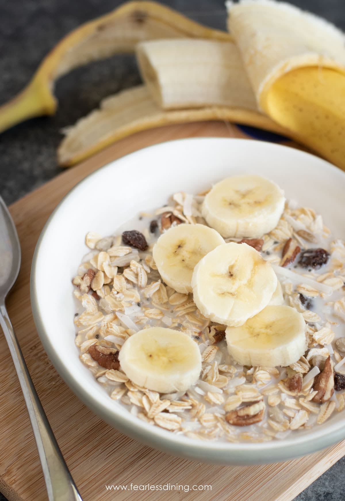 a bowl of muesli topped with sliced bananas