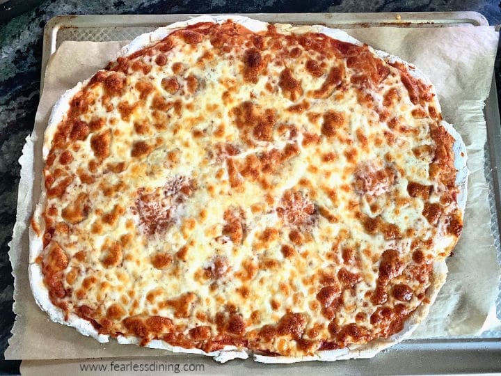 The top view of a gluten free pizza that has been baked.