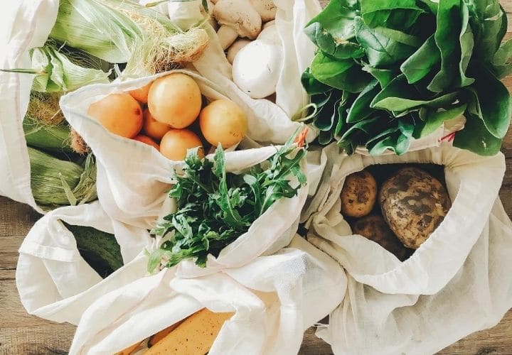 Grocery bags of vegetables.