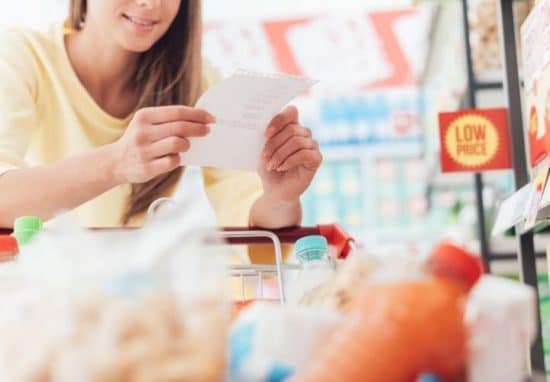 a grocery shopper holding a shopping list