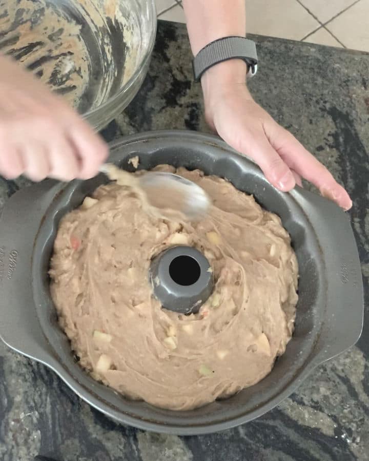 Spreading the cake batter in the bundt pan.