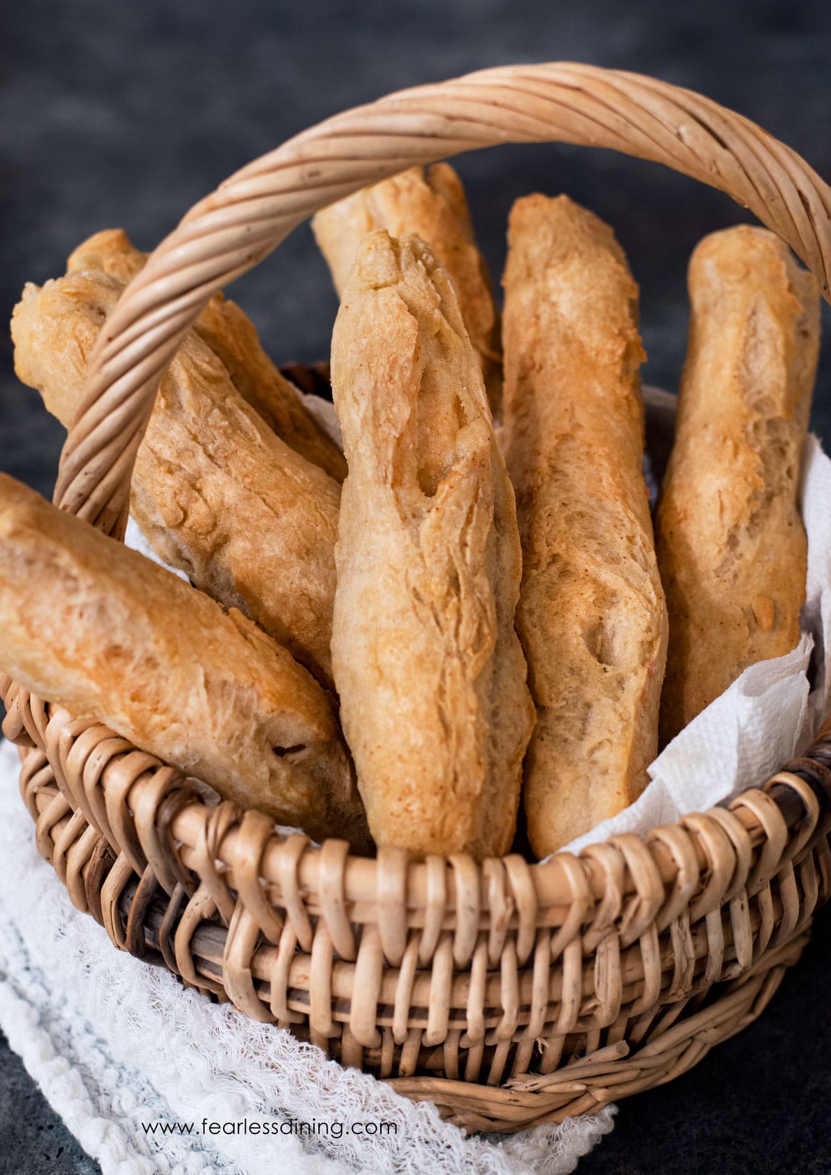 A basket of crispy gluten free breadsticks.