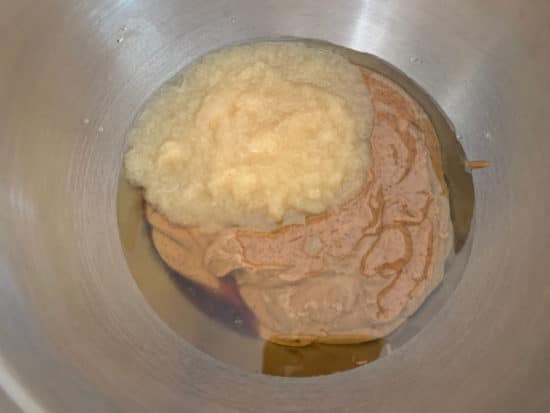Wet ingredients in a large silver mixing bowl.