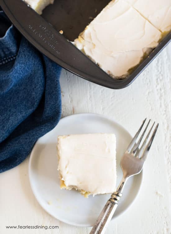 The top view of a slice of poke cake next to the cake pan.