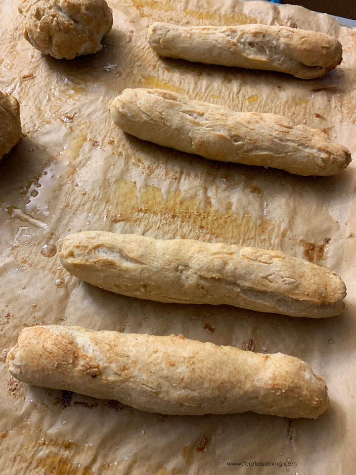 The baked gluten free breadsticks on a baking tray.