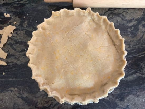 The top crust added and the edges pinched together. The pie is ready to bake.