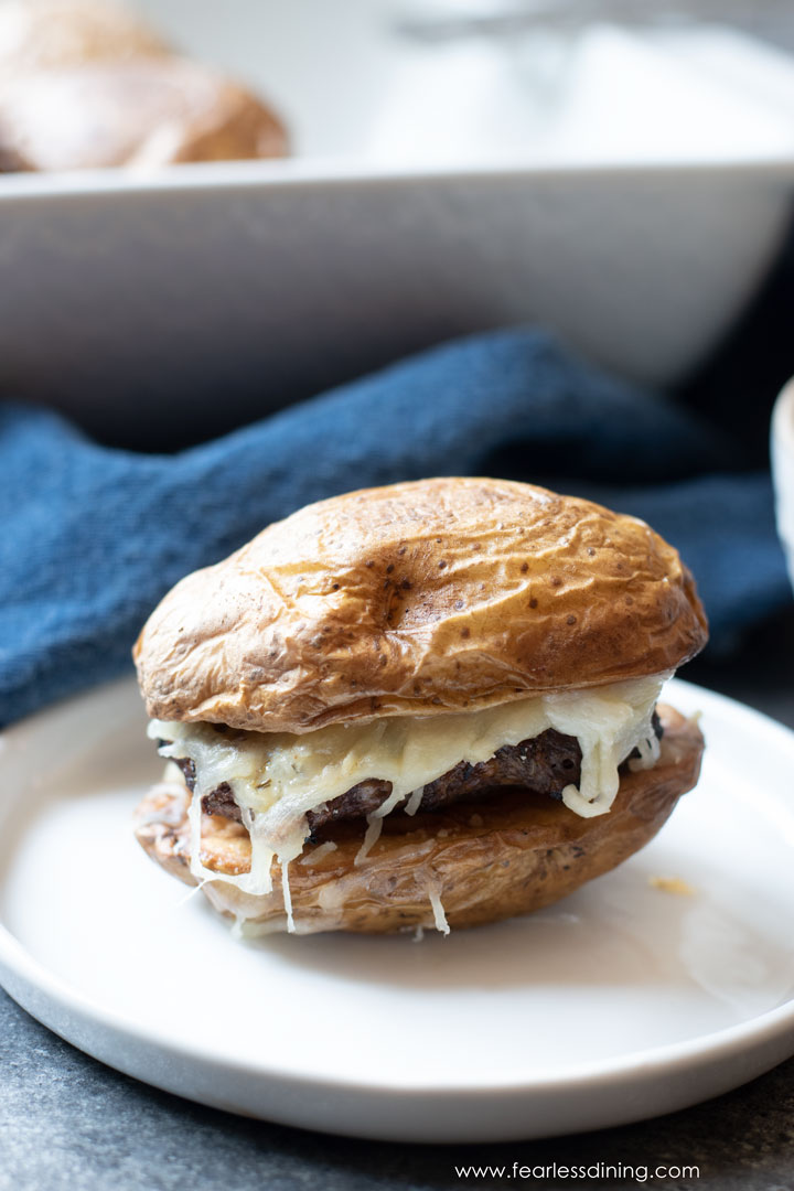 A lamb slider with a potato bun on a plate.