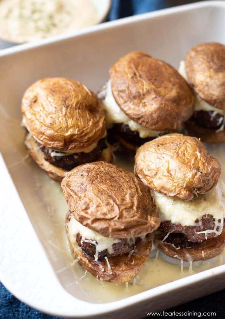 Lamb sliders on potato buns in a serving dish.