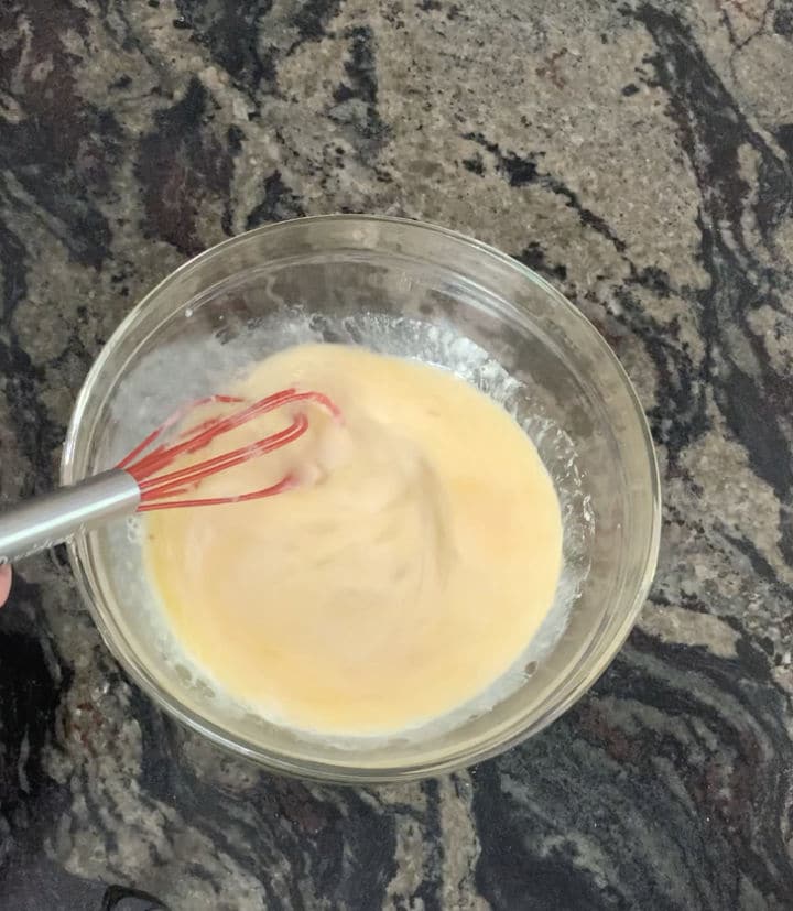 A glass bowl with the ingredients whisked.