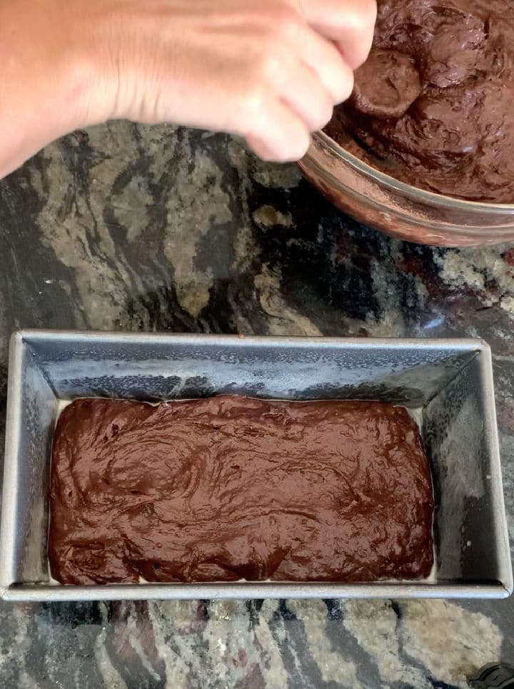 Adding the chocolate cake batter layer.