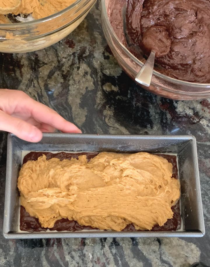 The pumpkin and chocolate batters in the loaf pan.