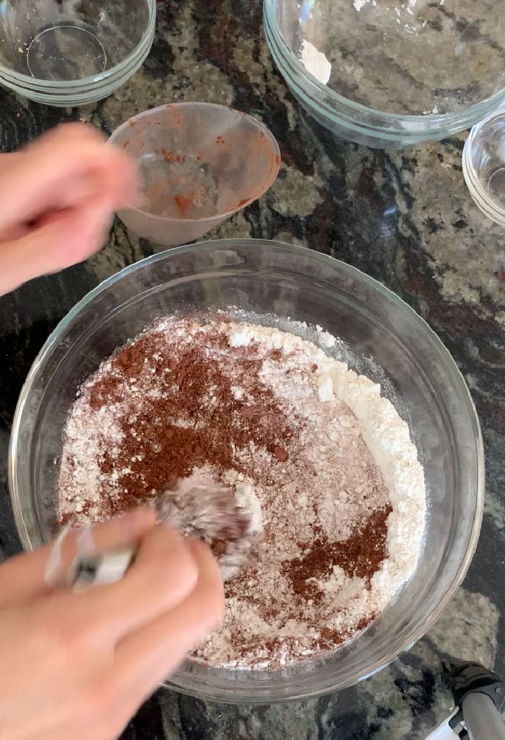 whisking the dry chocolate cake ingredients in a bowl