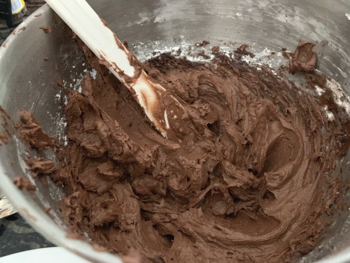 Rich chocolate frosting in a mixing bowl.